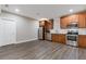 Kitchen with stainless steel appliances, wood cabinetry, subway tile backsplash, and laminate flooring at 5055 Stefan Ridge Way, Buford, GA 30519