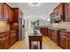 Spacious kitchen with wooden cabinets, granite countertops, stainless steel appliances, and hardwood floors at 5055 Stefan Ridge Way, Buford, GA 30519