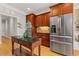 Gourmet kitchen with stainless steel appliances, hardwood floors, granite countertops, and dark wood cabinetry at 5055 Stefan Ridge Way, Buford, GA 30519