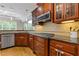 Kitchen showcasing wood cabinetry, granite counters, backsplash, and stainless steel appliances at 5055 Stefan Ridge Way, Buford, GA 30519