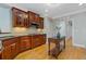 The kitchen boasts hardwood flooring, stainless steel appliances, dark granite countertops, and dark cabinets at 5055 Stefan Ridge Way, Buford, GA 30519