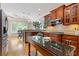 Bright kitchen featuring wooden cabinets, stainless appliances, and island with granite countertop at 5055 Stefan Ridge Way, Buford, GA 30519