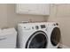 Updated laundry room featuring modern washer and dryer and sink basin at 5055 Stefan Ridge Way, Buford, GA 30519