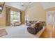Open living room boasts high ceilings, a ceiling fan, large windows, hardwood floors, and comfortable seating arrangement at 5055 Stefan Ridge Way, Buford, GA 30519