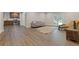 Open-concept space with living area and kitchen featuring wood cabinets and stainless appliances at 5055 Stefan Ridge Way, Buford, GA 30519