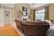 Inviting living room with custom built-ins, fireplace, large windows, and hardwood flooring at 5055 Stefan Ridge Way, Buford, GA 30519