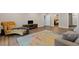 Open-concept living room with hardwood floors, a large area rug and comfortable seating at 5055 Stefan Ridge Way, Buford, GA 30519