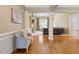 Open-concept living space with hardwood floors, columns, and a view into the adjacent seating area at 5055 Stefan Ridge Way, Buford, GA 30519