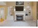 Living room featuring a fireplace, built-in shelves, neutral colored walls, and soft carpet flooring at 5055 Stefan Ridge Way, Buford, GA 30519