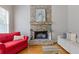 Comfortable living room with stone fireplace and hearth, and hardwood floors at 5055 Stefan Ridge Way, Buford, GA 30519