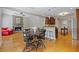 Open concept living space featuring a fireplace, hardwood flooring, a dining area, and a view of the kitchen at 5055 Stefan Ridge Way, Buford, GA 30519