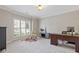 Bright home office featuring neutral walls, carpet flooring, modern desk, and shuttered windows allowing ample natural light at 5055 Stefan Ridge Way, Buford, GA 30519
