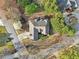 Aerial view of a home in a lush neighborhood, showcasing the driveway and mature landscaping at 2305 Stonevalley Ct, Cumming, GA 30041