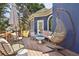 Private back porch offers comfortable seating, a hanging chair, and a charming place to relax outdoors at 2305 Stonevalley Ct, Cumming, GA 30041