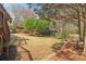 Spacious backyard with lush lawn, mature trees, and a play area, perfect for outdoor activities at 2305 Stonevalley Ct, Cumming, GA 30041