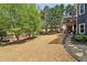 Spacious backyard offering a lawn, trees, and a patio area, creating a serene outdoor retreat at 2305 Stonevalley Ct, Cumming, GA 30041