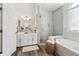 Bright bathroom features a glass-enclosed shower, soaking tub and white cabinets at 2305 Stonevalley Ct, Cumming, GA 30041