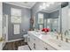 Elegant bathroom featuring double sink vanity, granite countertops, modern fixtures and walk-in shower at 2305 Stonevalley Ct, Cumming, GA 30041
