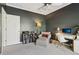 Charming bedroom features dark walls, crown molding, and a cozy reading nook with chair, ottoman and built in shelves at 2305 Stonevalley Ct, Cumming, GA 30041