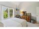 Bright bedroom with large windows, wooden accents and a cozy chair, providing a serene and inviting space at 2305 Stonevalley Ct, Cumming, GA 30041