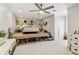 Modern bedroom featuring a platform bed, ceiling fan, and carpet flooring at 2305 Stonevalley Ct, Cumming, GA 30041