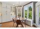 Bright dining area off the kitchen with bay windows, hardwood floors, and a stylish chandelier at 2305 Stonevalley Ct, Cumming, GA 30041
