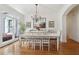 Bright dining room featuring hardwood floors, chandelier lighting, and large windows with backyard views at 2305 Stonevalley Ct, Cumming, GA 30041