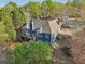Elevated view of a home with a deck, patio, and landscaped yard, blending comfort with nature at 2305 Stonevalley Ct, Cumming, GA 30041