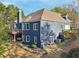 Two-story home with a backyard, deck, patio, and staircase, complemented by attractive landscaping at 2305 Stonevalley Ct, Cumming, GA 30041