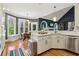 Modern kitchen featuring stainless steel appliances, white cabinetry, and granite countertops at 2305 Stonevalley Ct, Cumming, GA 30041
