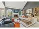 Spacious living room with vaulted ceiling, fireplace, built-in shelving, and comfortable seating at 2305 Stonevalley Ct, Cumming, GA 30041