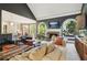 Spacious living room with vaulted ceiling, fireplace, built-in shelving, and comfortable seating at 2305 Stonevalley Ct, Cumming, GA 30041