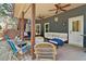 Relaxing covered porch features comfortable seating arrangements, outdoor ceiling fans, and views of yard at 2305 Stonevalley Ct, Cumming, GA 30041