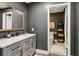 Stylish powder room boasts a vanity with marble top, elegant mirror, and tastefully decorated toilet area at 2305 Stonevalley Ct, Cumming, GA 30041