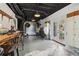 Bright studio space with black ceiling features wooden work spaces, lounge area, and white storage cabinets at 2305 Stonevalley Ct, Cumming, GA 30041
