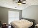 Comfortable bedroom with a ceiling fan and ample natural light at 801 Old Peachtree Nw Rd # 15, Lawrenceville, GA 30043