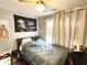 Cozy bedroom with hardwood floors, natural light, and a ceiling fan at 801 Old Peachtree Nw Rd # 15, Lawrenceville, GA 30043