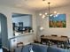 Open-concept dining area with modern light fixtures and a view into the adjacent kitchen at 801 Old Peachtree Nw Rd # 15, Lawrenceville, GA 30043