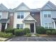 Charming townhome featuring a well-maintained lawn and a welcoming front entrance at 801 Old Peachtree Nw Rd # 15, Lawrenceville, GA 30043