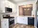 Bright kitchen with white cabinets, stainless steel appliances, and black accents at 801 Old Peachtree Nw Rd # 15, Lawrenceville, GA 30043