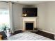 Cozy living room with a fireplace, large windows, and a view of the outdoors at 801 Old Peachtree Nw Rd # 15, Lawrenceville, GA 30043