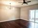 Open living space featuring hardwood floors, modern lighting, and a sliding glass door at 801 Old Peachtree Nw Rd # 15, Lawrenceville, GA 30043