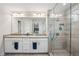 Bathroom with double sinks, large mirror and glass shower with tiled walls and herringbone floor at 2048 Violet Lane, Brookhaven, GA 30319