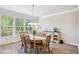 Light-filled dining room featuring a wooden table, chairs, and a buffet along the wall at 2048 Violet Lane, Brookhaven, GA 30319