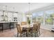 Bright dining area with an elegant wooden table and large windows overlooking the yard at 2048 Violet Lane, Brookhaven, GA 30319