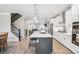 Gorgeous kitchen with stainless steel appliances, a center island with bar seating, and an adjacent staircase and living room at 2048 Violet Lane, Brookhaven, GA 30319
