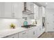 Bright kitchen featuring white cabinets, quartz countertops, and stainless steel appliances at 2048 Violet Lane, Brookhaven, GA 30319