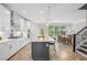 Bright kitchen with stainless steel appliances, a center island with bar seating, and view of the dining area at 2048 Violet Lane, Brookhaven, GA 30319