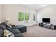 Cozy living room area, with carpet, a large window and comfortable sectional sofa at 2048 Violet Lane, Brookhaven, GA 30319