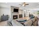 Open-concept living room with fireplace, television, hardwood floors, and view of the kitchen, great for entertaining at 2048 Violet Lane, Brookhaven, GA 30319